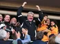 Hull City's manager Steve Bruce celebrates in the stands after his side sealed promotion to the Premier League on May 4, 2013