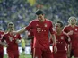 Bayern's Mario Gomez is congratulated by team mates after scoring the equaliser against Dortmund on May 4, 2013