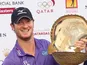 Chris Wood poses with the trophy after winning the Qatar Masters on January 26, 2013 