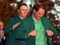 Jordan Spieth hands Danny Willett his green jacket at The Masters on April 10, 2016