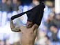 Jack Wilshere removes his shirt and gives it to a pitch invader during the Premier League game between Everton and Arsenal on October 22, 2017