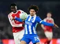 Arsenal's Bukayo Saka (left) and Brighton and Hove Albion's Ferdi Kadioglu (right) battle for the ball on March 4, 2026