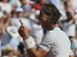 Spain's Rafael Nadal gestures as he defeats Serbia's Novak Djokovic during their semifinal match of the French Open tennis tournament on June 7, 2013