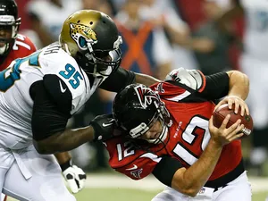 D'Anthony Smith #95 of the Jacksonville Jaguars pressures Sean Renfree #12 of the Atlanta Falcons at Georgia Dome on August 29, 2013