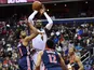 Denver Nuggets forward Paul Millsap (4) shoots as Washington Wizards guard Chasson Randle (9) and forward Jabari Parker (12) and forward Wesley Johnson (4) look on during the first half at Capital One Arena on March 22, 2019