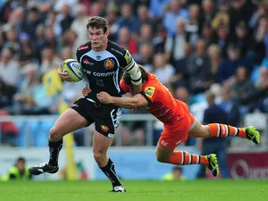 Ian Whitten of Exeter Chiefs is tackled by Anthony Allen of Leicester Tigers during the Aviva Premiership match between Exeter Chiefs and Leicester Tigers at Sandy Park on September 13, 2014