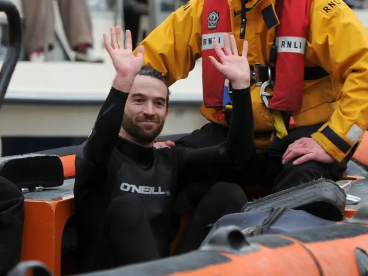 Boat Race interrupted by swimmer