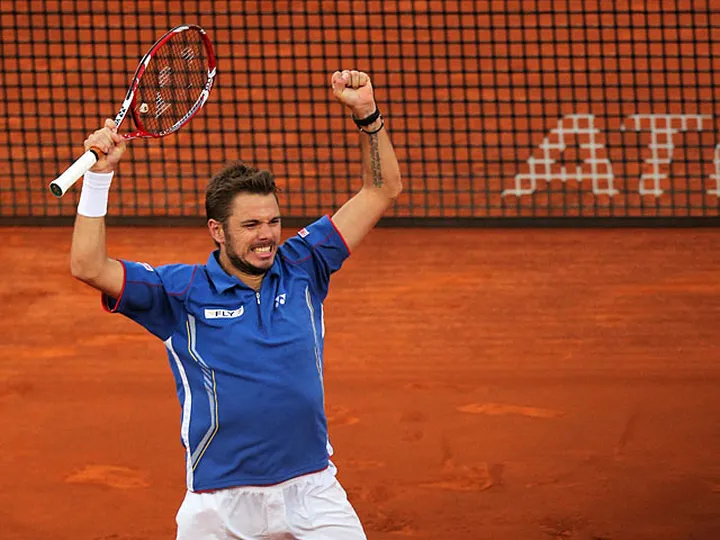 Wawrinka battles into second round