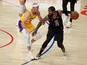 LA Clippers guard Paul George handles the ball while defended by Los Angeles Lakers guard Alex Caruso on May 7, 2021