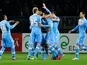 Napoli's Blerim Dzemaili is mobbed by team mates after scoring the opener against Torino on March 30, 2013