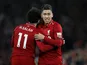 Liverpool striker Roberto Firmino celebrates with Mohamed Salah after scoring against Arsenal on December 29, 2018