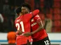 Bayer Leverkusen's Edmond Tapsoba and Amine Adli celebrate after the match on March 9, 2023