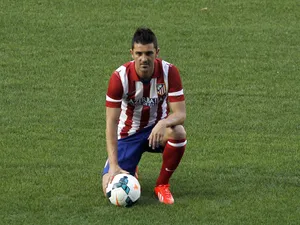Atletico de Madrid's new player David Villa poses for a picture during his presentation at the Vicente Calderon Stadium on July 15, 2013