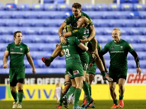 London Irish players celebrate with Shane Geraghty after he kicks the winning points with a drop goal during the Aviva Premiership match between London Irish and Exeter Chiefs at Madejski Stadium on January 11, 2015