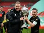 Harrogate Town's Josh Falkingham and manager Simon Weaver celebrate with the trophy after winning the FA Trophy Final on May 3, 2021