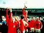 Bobby Moore holds the trophy aloft after England's 4-2 victory against West Germany in the 1966 FIFA World Cup final