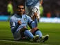 Carlos Tevez celebrating from the ground after scoring on November 17, 2012