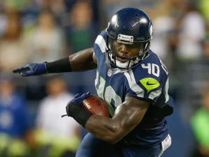 Running back Derrick Coleman #40 of the Seattle Seahawks rushes against the Oakland Raiders at CenturyLink Field on August 29, 2013