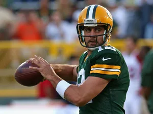 Aaron Rodgers #12 of the Green Bay Packers participates in warm-ups before a game against the Arizona Cardinals at Lambeau Field on August 9, 2013