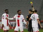 Dijon's Ngonda Muzinga is shown a yellow card by referee Jeremie Pignard in January 2021