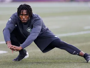 Cornerback Antonio Cromartie #31 of the New York Jets stretches before the Jets take on the New England Patriots at Gillette Stadium on September 12, 2013