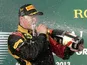 Lotus driver Kimi Raikkonen celebrates with champagne after winning the Australian Formula One Grand Prix on March 17, 2013