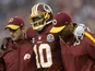 Robert Griffin III of the Washington Redskins is helped off the field on December 9, 2012