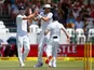 Stuart Broad and James Anderson celebrate taking the wicket of AB de Villiers on day three of the second Test between South Africa and England on January 4, 2016