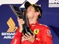 Ferrari's Sebastian Vettel kisses the trophy as he celebrates after winning the race in Singapore on September 22, 2019