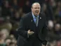 Rafael Benitez squats and barks during the Premier League game between Manchester United and Newcastle United on November 18, 2017