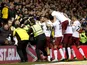 Aston Villa's Kortney Hause celebrates scoring their third goal against Nottingham Forest as stewards apprehend a fan on March 13, 2019