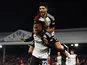 Fulham's Alex Iwobi celebrates scoring their first goal with Raul Jimenez on December 6, 2023