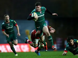 Freddie Burns of Leicester Tigers is tackled by Lachlan McCaffrey of London Welsh during the Aviva Premiership match between London Welsh and Leicester Tigers at Kassam Stadium on November 23, 2014
