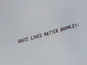 A banner reading 'White Lives Matter Burnley' flies over the Etihad on June 22, 2020