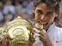 Rafael Nadal celebrates with the Wimbledon trophy.
