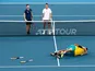 Australia's Alex de Minaur and Nick Kyrgios celebrate winning their Quarter Final doubles match against Britain's Jamie Murray and Joe Salisbury as they look on dejected on January 9, 2020