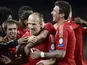 Bayern forward Arjen Robben is mobbed by team mates after scoring the opening goal against Barcelona on May 1, 2013