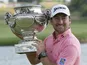 Graeme McDowell of Northern Ireland holds the trophy during the winning ceremony of the French Open Golf tournament on July 7, 2013