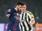 Khvicha Kvaratskhelia of Paris Saint-Germain and Dan Burn of Newcastle United in action on January 28, 2026