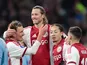Mika Godts (L) celebrates a goal with Ajax teammates on February 14, 2026