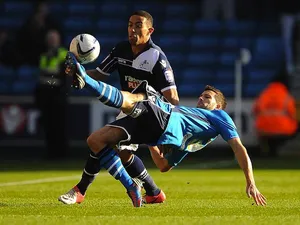 Adam Drury clears the ball away from Liam Feeney on November 18, 2012