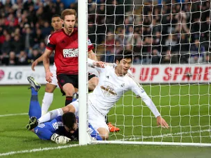 Swansea climb out of relegation zone