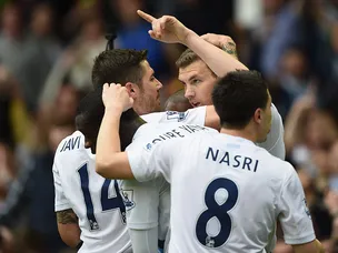Dzeko double sends Man City top
