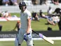 England's Rory Burns walks off the pitch dejected after his wicket is taken by New Zealand's Colin de Grandhomme on November 21, 2019