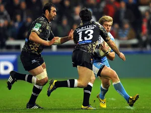 Charlie Amesbury of Sale Sharks is tackled by two Montpellier players during thier match on January 11, 2013
