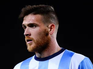Ten-man Malaga battle to victory