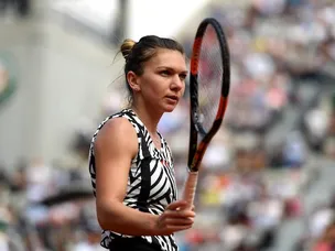 Halep recovers to earn place in round four