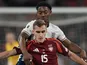 England's Myles Lewis-Skelly and Latvia's Dmitrijs Zelenkovs compete for the ball on March 24, 2025