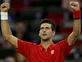Angry Djokovic powers past Tsonga
