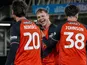 Luton Town's Mads Andersen celebrates with Lasse Nordas and Joe Johnson on December 2, 2025
